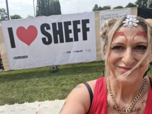 Melissa at Tramlines next to I Love Sheffield sign